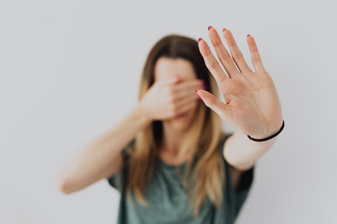 A girl hiding her eyes, scared to see something she has phobia from